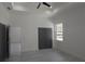 Bright bedroom with tray ceiling, ceiling fan, and gray closet doors at 7013 N 15Th St, Tampa, FL 33610