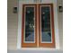 Stylish double front doors with glass panels, modern sconces, and visible house number at 7013 N 15Th St, Tampa, FL 33610