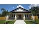 Charming single-story home with craftsman details, a welcoming porch, and a well-manicured lawn at 7013 N 15Th St, Tampa, FL 33610