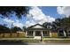 Inviting single-story home with lush green lawn, fresh landscaping and wood fence at 7013 N 15Th St, Tampa, FL 33610