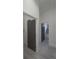 The hallway features grey doors and light colored floors at 7013 N 15Th St, Tampa, FL 33610