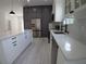 Stylish kitchen with stainless steel appliances, white cabinets, and quartz countertops at 7013 N 15Th St, Tampa, FL 33610