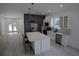 Bright open kitchen with a large center island, stainless steel appliances, and wood laminate flooring at 7013 N 15Th St, Tampa, FL 33610