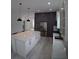 Modern kitchen featuring an island, stainless steel refrigerator, and sleek gray and white cabinetry at 7013 N 15Th St, Tampa, FL 33610