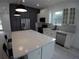 Bright, modern kitchen with white cabinets, stainless steel appliances, and a large center island at 7013 N 15Th St, Tampa, FL 33610