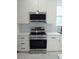 New stainless steel range and microwave, white cabinetry and quartz countertops at 7013 N 15Th St, Tampa, FL 33610