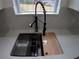 Close up of kitchen sink and faucet with quartz countertops and stainless steel accessories at 7013 N 15Th St, Tampa, FL 33610