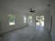 Bright living room with wood laminate floors and sliding doors leading to the backyard at 7013 N 15Th St, Tampa, FL 33610