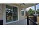 Covered porch featuring black railing, a sliding glass door, and a black ceiling fan at 7013 N 15Th St, Tampa, FL 33610