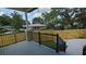 Covered porch featuring black railing overlooking the fenced in back yard at 7013 N 15Th St, Tampa, FL 33610