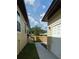 View of side yard, with fence and a partial view of main house and detached garage at 7013 N 15Th St, Tampa, FL 33610
