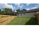 Backyard featuring a green lawn and a new wooden privacy fence at 7013 N 15Th St, Tampa, FL 33610