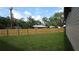 Backyard featuring a green lawn and a new wooden privacy fence at 7013 N 15Th St, Tampa, FL 33610