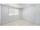 This bedroom features white walls, neutral tile flooring, a ceiling fan and natural light from a single window at 7125 14Th S Ave, South Pasadena, FL 33707