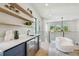 Modern bar area with floating shelves, mini fridge, and bright natural light in a stylish home at 715 W Peninsular St, Tampa, FL 33603
