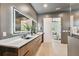 Modern bathroom featuring a double vanity, wood cabinetry, and illuminated mirror for a bright space at 715 W Peninsular St, Tampa, FL 33603