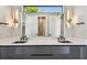 Elegant bathroom featuring dual sinks with quartz countertops, undermount sinks, and modern gold light fixtures at 715 W Peninsular St, Tampa, FL 33603