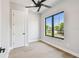 Well-lit bedroom boasts hardwood floors, a closet, and a large black trimmed window at 715 W Peninsular St, Tampa, FL 33603