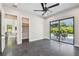 Modern bedroom with tile floors and a glass patio door leading to an outdoor seating area next to the pool at 715 W Peninsular St, Tampa, FL 33603
