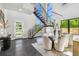 Bright, modern dining area with a glass table, chairs, and view of the open staircase with metal railings at 715 W Peninsular St, Tampa, FL 33603