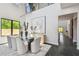 Modern dining room featuring a glass table, stylish chairs, and an open view to the home's entryway at 715 W Peninsular St, Tampa, FL 33603