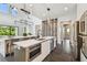 Bright, modern kitchen with stainless steel appliances, a wine rack, and an island with bar seating at 715 W Peninsular St, Tampa, FL 33603