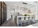Open layout showcasing a modern kitchen with an island, wine rack, and sleek, white cabinetry at 715 W Peninsular St, Tampa, FL 33603