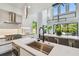 Modern kitchen with white cabinetry, stainless steel appliances, and a large island with a breakfast bar at 715 W Peninsular St, Tampa, FL 33603