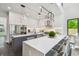 Sleek kitchen boasts an island with seating, stainless steel appliances, and modern pendant lighting at 715 W Peninsular St, Tampa, FL 33603