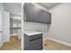 Well-organized laundry room with sleek gray cabinets, counter space, and easy access to walk-in closet at 715 W Peninsular St, Tampa, FL 33603
