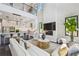 Open-concept living room with high ceilings, fireplace, and views of the modern kitchen at 715 W Peninsular St, Tampa, FL 33603