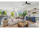 Bright living room area with a wet bar, hardwood floors, a ceiling fan, and plenty of natural light at 715 W Peninsular St, Tampa, FL 33603