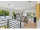 Bright and airy living room with hardwood floors, large windows, a comfortable sofa, and a modern bar area at 715 W Peninsular St, Tampa, FL 33603