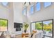 Bright living room with high ceilings, a fireplace, and large windows overlooking the pool at 715 W Peninsular St, Tampa, FL 33603