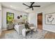 Stylish main bedroom showcasing a luxurious bed, neutral colors, and a modern ensuite bathroom at 715 W Peninsular St, Tampa, FL 33603