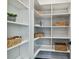 Organized walk-in pantry with white shelving and ample storage space, ideal for kitchen essentials at 715 W Peninsular St, Tampa, FL 33603