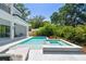 Inviting pool and spa complemented by stylish lounge chairs in landscaped backyard at 715 W Peninsular St, Tampa, FL 33603