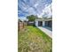 A spacious backyard featuring a concrete patio and fenced perimeter that offers privacy and room for outdoor activities at 843 Greenfield Dr, Palm Harbor, FL 34684