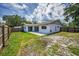 Fenced backyard of the house with a concrete patio and ample space for gardening or outdoor activities at 843 Greenfield Dr, Palm Harbor, FL 34684