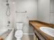 Bathroom features a bathtub with shower, wood vanity, and ceramic tile floors at 843 Greenfield Dr, Palm Harbor, FL 34684