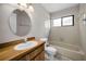 Bathroom features a bathtub with shower, wood vanity, and ceramic tile floors at 843 Greenfield Dr, Palm Harbor, FL 34684