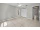 Bedroom with tile floors, neutral paint, and closet at 843 Greenfield Dr, Palm Harbor, FL 34684