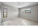 Bedroom with tile floors, neutral paint, and two windows providing ample natural light at 843 Greenfield Dr, Palm Harbor, FL 34684