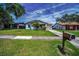 Charming single-story home with a well-maintained lawn, lovely landscaping, and an attached garage at 843 Greenfield Dr, Palm Harbor, FL 34684