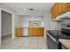 Well-lit kitchen featuring stainless steel appliances, wood cabinets, and tile flooring at 843 Greenfield Dr, Palm Harbor, FL 34684