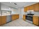 Updated kitchen with stainless steel appliances and natural wood cabinets at 843 Greenfield Dr, Palm Harbor, FL 34684