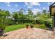 Lush backyard with brick patio, mature trees, and manicured lawn creates a private oasis at 4222 Hartwood Ln # 1202, Tampa, FL 33618