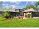 Well-maintained backyard with a lush lawn, mature trees and a screened in porch at 4222 Hartwood Ln # 1202, Tampa, FL 33618
