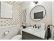 Stylish half bathroom with marble countertops, unique fixtures, decorative wallpaper, and a round mirror at 4222 Hartwood Ln # 1202, Tampa, FL 33618