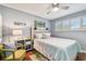 Cozy bedroom with wood flooring, a comfortable bed, and lots of natural light from the white shuttered window at 4222 Hartwood Ln # 1202, Tampa, FL 33618